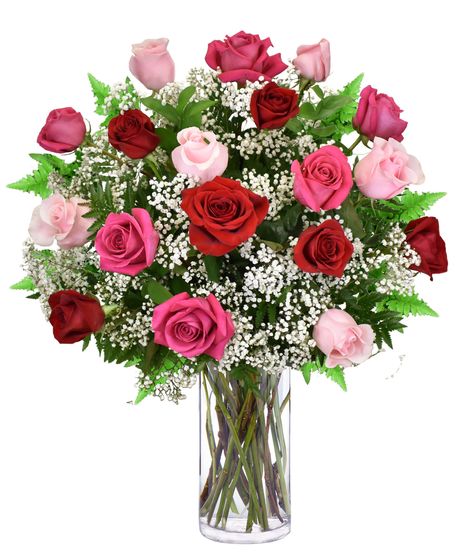 Pink and red roses with baby's breath in a glass vase