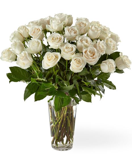 white roses in a clear vase