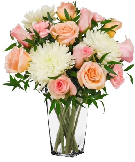 soft peach roses, pink carnations, and white mums in a clear glass vase