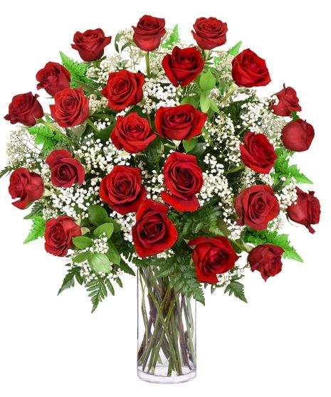Red roses arranged in a clear glass vase with baby's breath and greenery.
